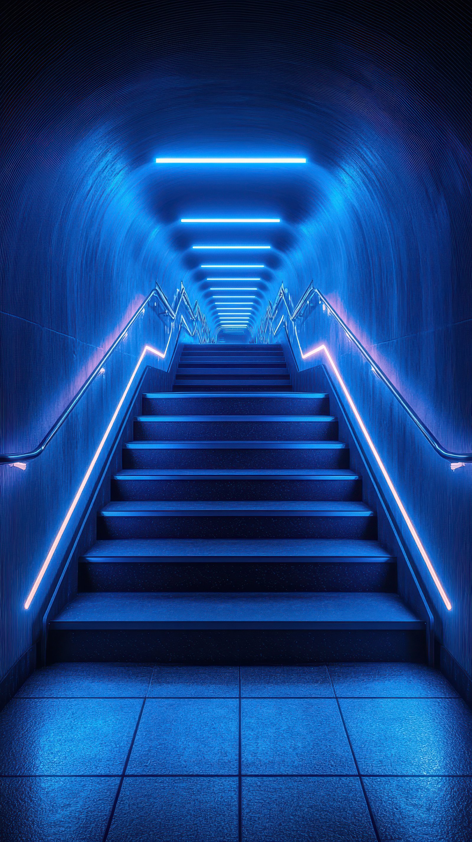 Blue illuminated stairway leading upwards in a modern underground pedestrian passage on a clear evening